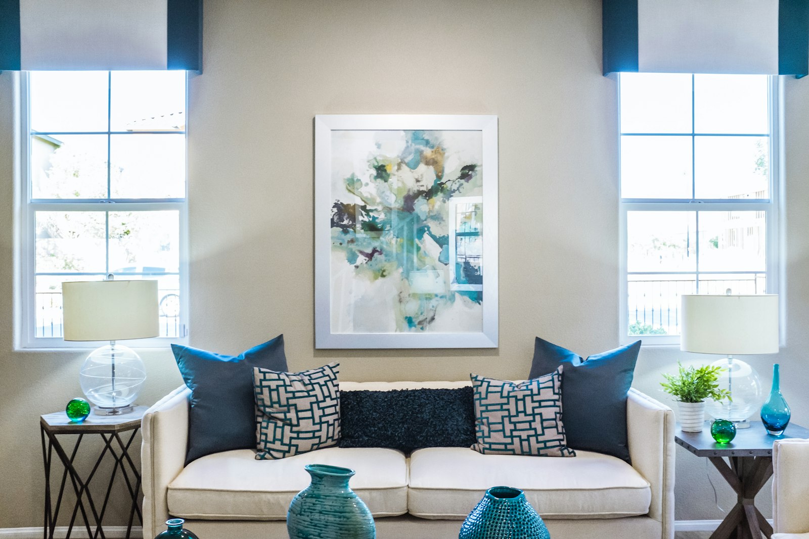 Bright staged living room with a neutral sofa and fresh decor